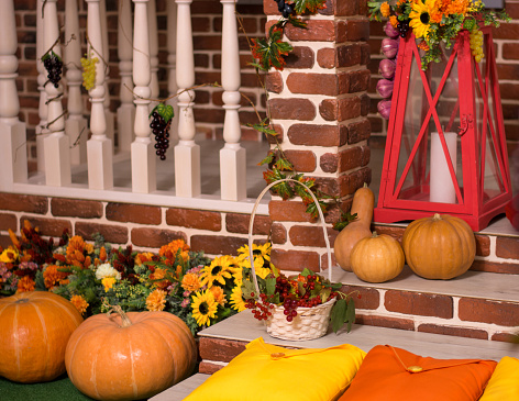 Atmospheric Fall or Thanksgiving background with a collection of pumpkins and a THANKFUL sign. Wood background for text