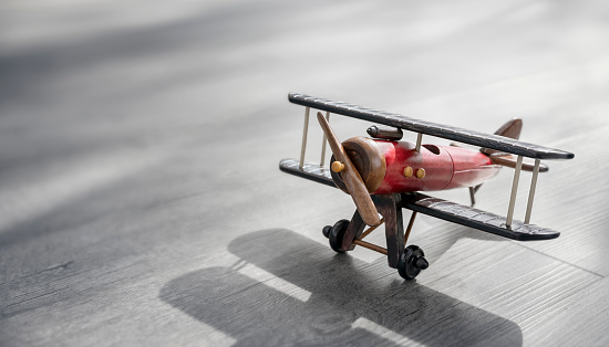 Wooden toy biplane aeroplane background concept for air travel, tourism and vacation abroad