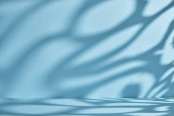 istock Backdrop for product presentation. Blue background with ornate shadows and light. 1342632238
