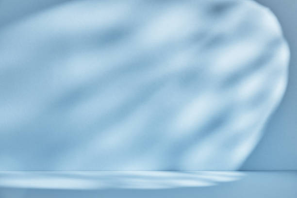 istock Backdrop for product presentation. Blue background with drop shadows and light. 1342632243