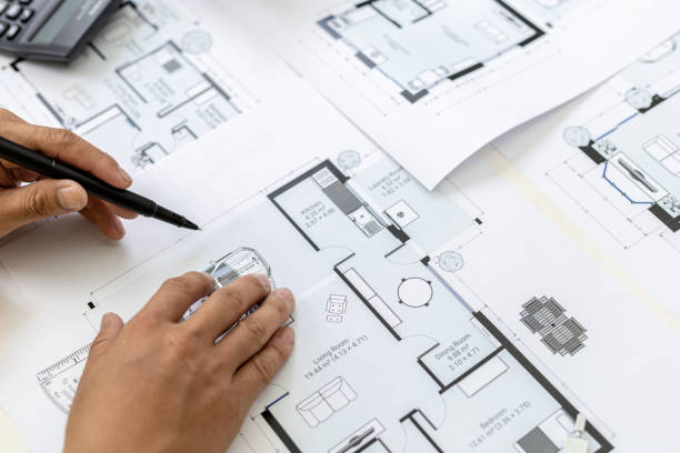 istock The architect checks the blueprints he has designed, he is checking the correctness and correcting the house designs before bringing them to the customer. Design and interior design ideas. 1342632676