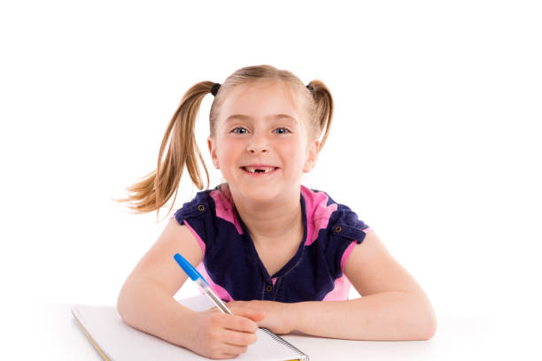 Blond kid indented girl student with spiral notebook in pupil desk