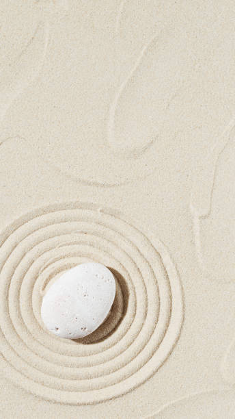 istock Background with zen stone on sand. Zen Garden with concentric circles around pebble 1342687482