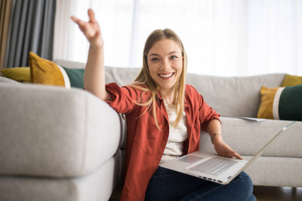 istock Happy young woman using laptop at home. 1342701648