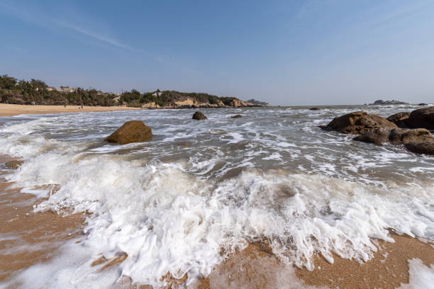 istock The white waves beat against the black rocks 1342706852