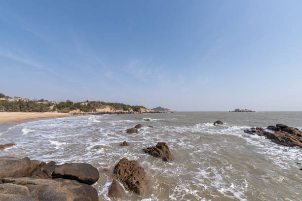 istock The white waves beat against the black rocks 1342706937
