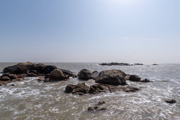 istock The white waves beat against the black rocks 1342706941