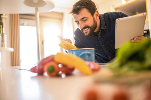 istock Young man enjoys cooking at home. 1342707262