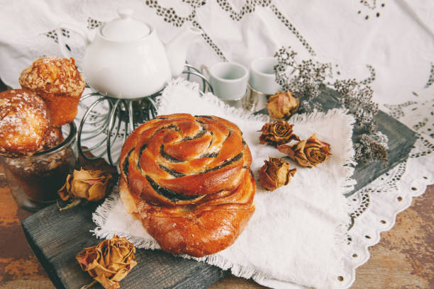 Puff pastry, sliced poppy seed roll, sweet poppy seed bun on a white plate. A traditional sweet poppy seed bun is served with coffee for Breakfast