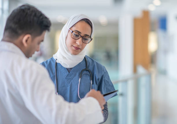 istock Two doctors discuss treatment plan in hospital corridor 1342708823