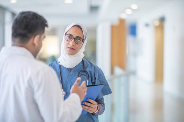 istock Two doctors discuss treatment plan in hospital corridor 1342708832