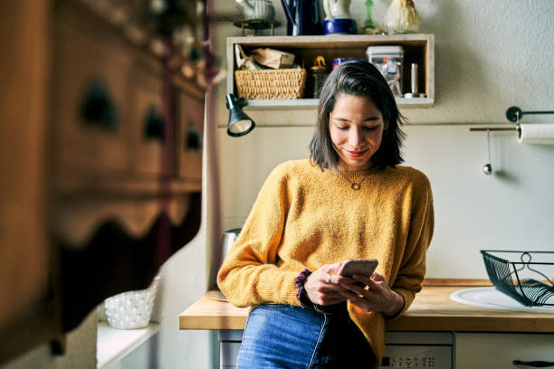 istock Woman at home using mobile phone 1342716682