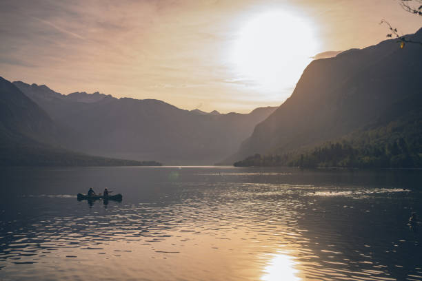 istock Friends paddle through tranquil alpine lake in canoe 1342727041