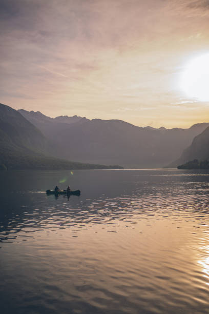 istock Friends paddle through tranquil alpine lake in canoe 1342727044