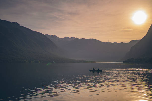 istock Friends paddle through tranquil alpine lake in canoe 1342727567