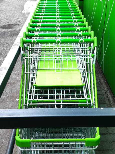 istock Green shopping carts together in a line up 1342740015
