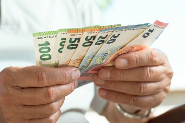 istock Senior Man Counting Money 1342746758