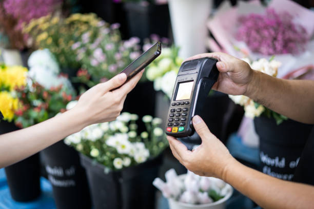 istock A female customer uses her mobile phone to make a payment in a store 1342769075
