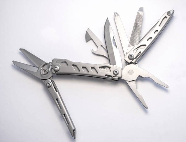 istock Miniature, pocket-sized universal Multi tool containing a knife, opener, pliers, scissors and  file. 1342780721