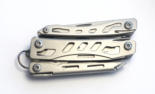Miniature, pocket-sized universal Multi tool containing a knife, opener, pliers, scissors and a file.
