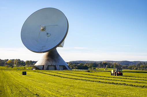 agricultural tractor in front of Raisting Radome Satellite