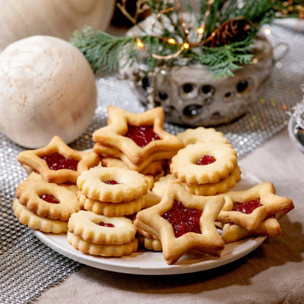 istock Christmas Linz shortbread biscuits cookies with wooden decorations on xmas table 1342784774