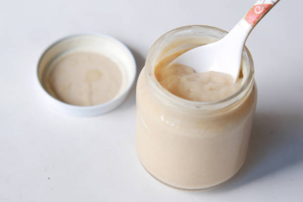 istock baby food in a container on table with copy space. 1342791338