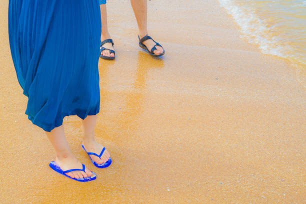 Feet of women who walk the sandy beach. Shooting Location: Thailand, Pattaya