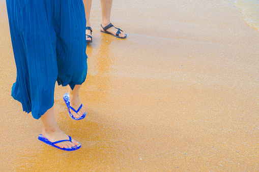 Feet of women who walk the sandy beach. Shooting Location: Thailand, Pattaya