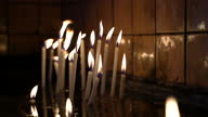 istock 4k video footage of burning candles in a church, Close up view 1342793549