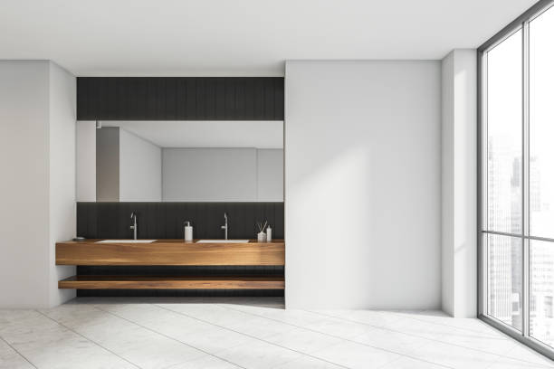 istock White bathroom with black tile and wood alike vanity area 1342801885