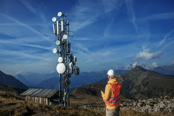 A male engineer utility worker at a telecom tower mountain site