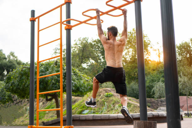 istock Muscular athletic man doing gymnastic exercises on the horizontal bar 1342807418