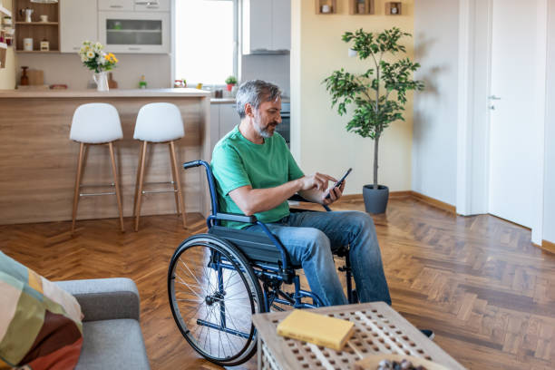 Disabled mature man texting on smartphone