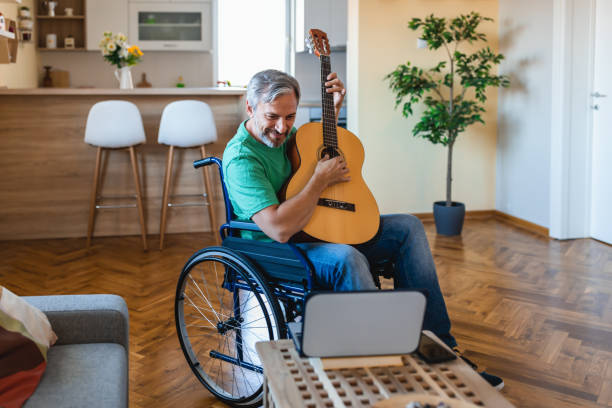 istock Mature men  learns to play guitar online using al aptop 1342807626