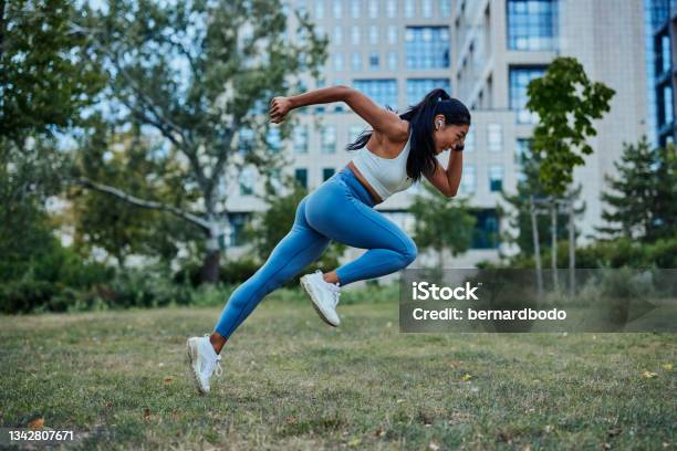 Asian Woman Running In Park To Achieve Her Personal Best Stock Photo - Download Image Now
