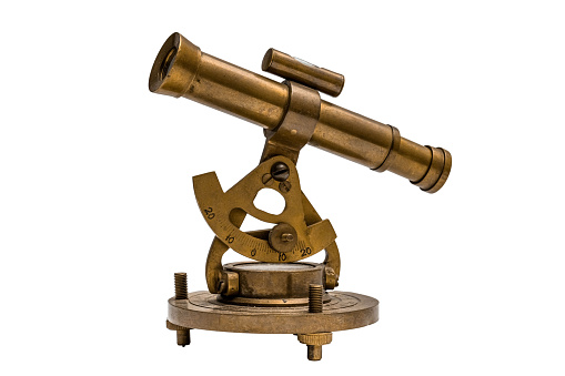 Old brass telescope on white background.