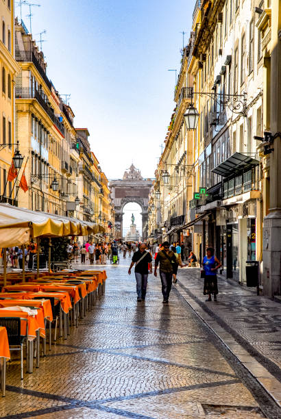 View looking straight down a main boulevard toward the  Arco da Rua Augusta which leads to the Praça do Comércio in Lisbon, Portugal.