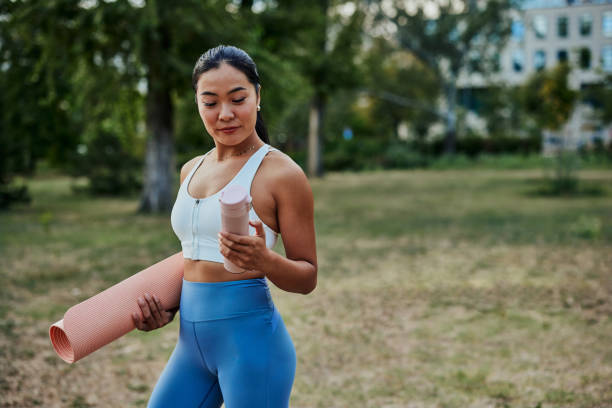 istock Tired young sportswoman holding water bottle after outdoors workout 1342809820