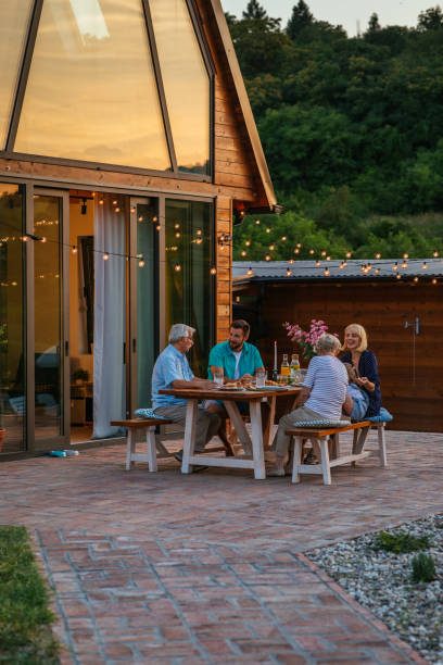 istock Affectionate family enjoying dinner during their get together in the backyard 1342811160