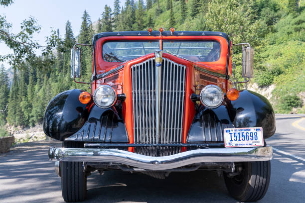 front view of the classic and historic red jammer tour buses along going to the sun road - us glacier national park montana bus park imagens e fotografias de stock