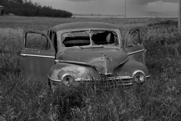 istock Old abandoned car in a field 1342815630