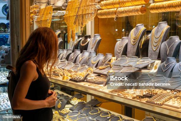 Woman Looking At Jewelery Showcase Stock Photo - Download Image Now - Gold - Metal, Gold Colored, Jeweller