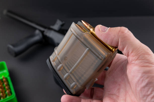 istock Loading 5.56mm assault rifle rounds into a magazine 1342817474