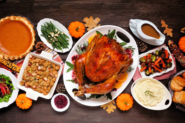 istock Traditional Thanksgiving turkey dinner overhead table scene on dark wood 1342817707