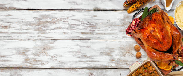 istock Classic Thanksgiving turkey dinner side border on a rustic white wood banner background 1342817734