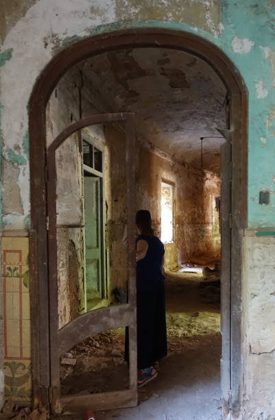 Ghost of a man in an abandoned building. Silhouette in the abandoned building. Ghost goes along corridor