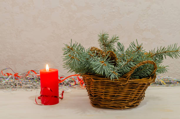 istock Christmas candle and wicker basket with christmas tree branch 1342821082