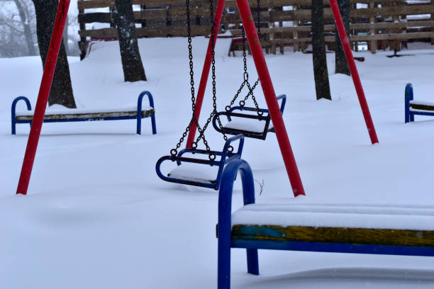 istock There is snow on the children's swing on metal chains. 1342821094