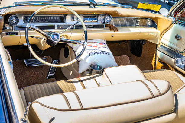 Fuzzy dice dangling from the rear view mirror of the vintage auto